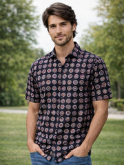 Man wearing a patterned Black Jahota Printed Cotton Shirt 10074313 shirt standing outdoors with greenery in the background