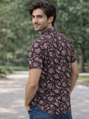 Man wearing a jahota printed cotton shirt standing outdoors with trees in the background